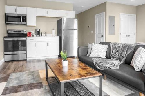 a living room with a couch and a table at 46 Bright and Sunny Studio Long-term stays in Chelsea