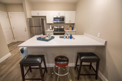 a kitchen with two bar stools and a counter top at Unit 23 Comfy 1BR Apartment Long-term stays in Chelsea