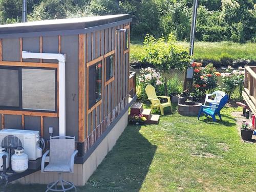 a small house with a yard with chairs and plants at Tiny Home By The Beach in Blaine