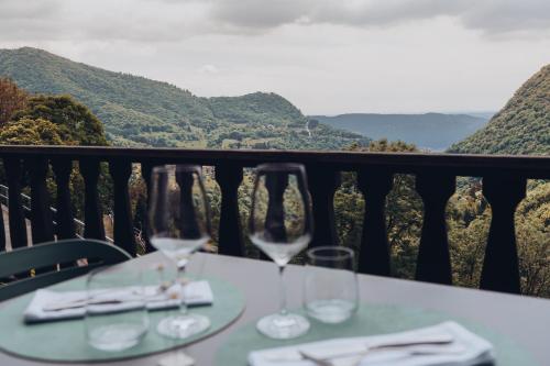 two wine glasses sitting on a table on a balcony at La Montanara in Casima