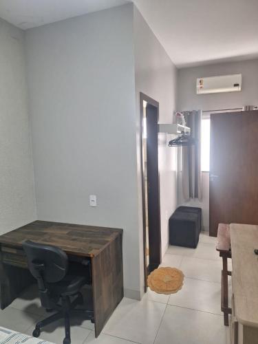 a office with a desk and a chair in a room at Apartamento vest unirv in Rio Verde