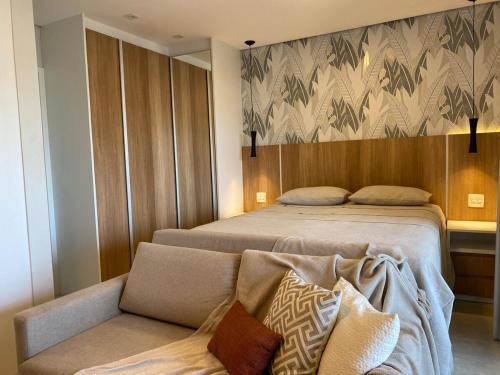 a hotel room with two beds and a couch at 20 floor perfect view Brooklin in Sao Paulo