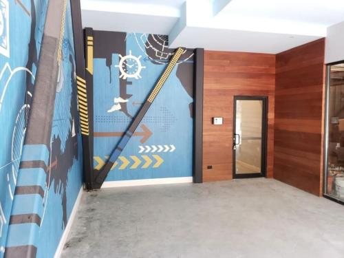 a hallway with a wall with a hockey mural at Unit 32 Stylish 1BR 1BA Apartment Long-term stays in Chelsea