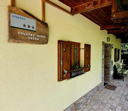a country house sign on the side of a building at Country House Srček in Bizeljsko