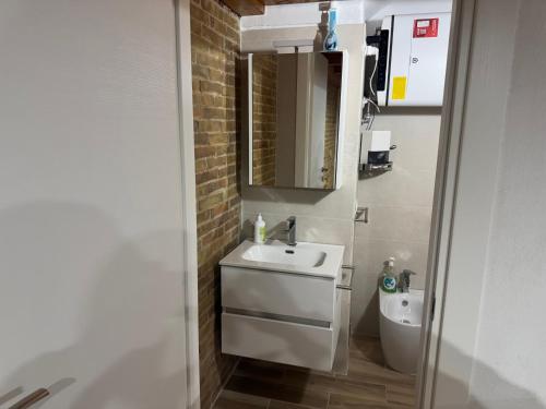 a bathroom with a sink and a toilet at B&C locazione turistica in Bernalda