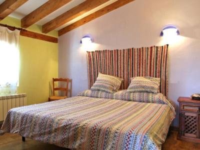a bedroom with a bed with two pillows on it at Casa Chaparrete in Deza