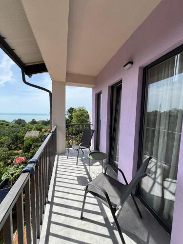 a balcony with chairs and a view of the ocean at Limonura in Tsikhisdziri