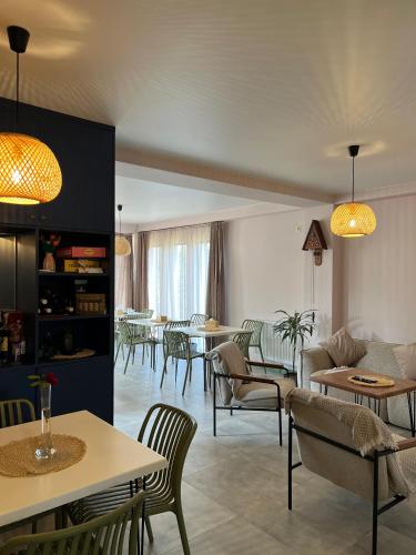 a living room with tables and chairs and a room with tables at Limonura in Tsikhisdziri