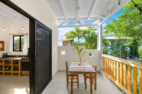 a dining room with a table and a large window at Casas Teresa Mar in Santa Teresa Beach