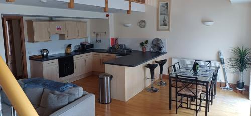 a kitchen with a counter and a table in a room at Marina Outlook in Milford Haven