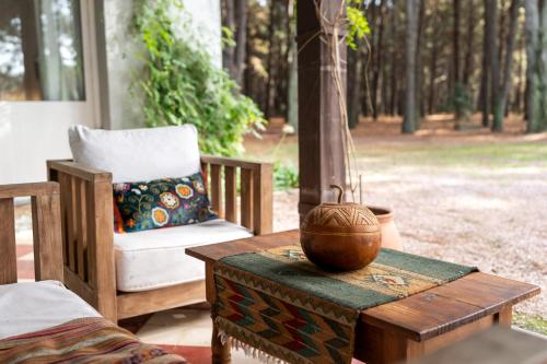 a wooden table with a vase on top of it at Chacra en Emprendimiento Tierra de Caballos in Colonia Estrella