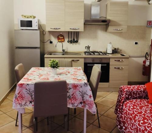 a kitchen with a table with a table cloth on it at Casa dei Fieschi - appartamento Bixio in Lavagna