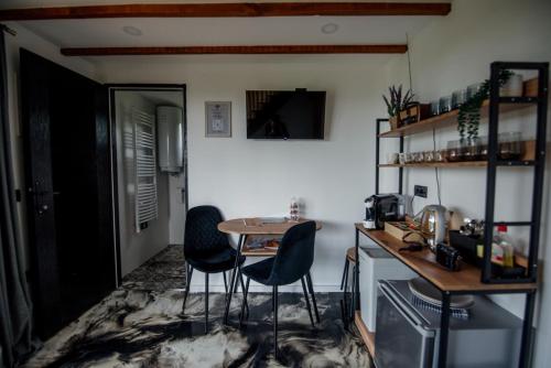 a small kitchen with a table and two chairs at Natura Bungalow in Ždrelo
