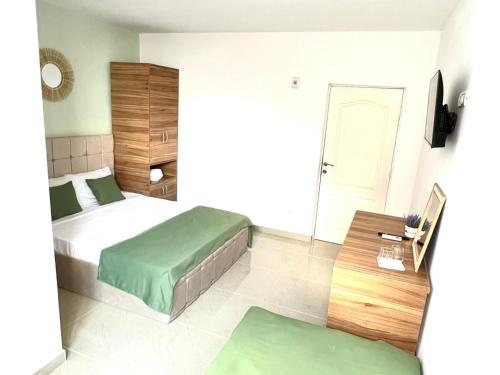 a small bedroom with two beds and a table at Vila Sedef Costinești in Costinesti