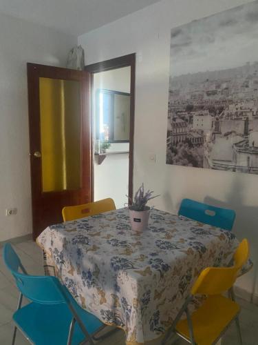 a dining room table with chairs and a potted plant on it at Paris in Alcalá de Henares