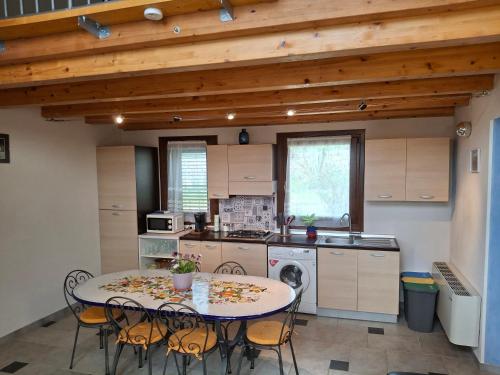a kitchen with a table and chairs in a room at L'Oasi del Mediterraneo in Sampieri