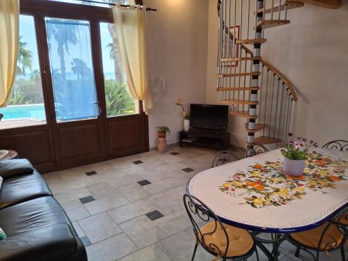 a living room with a table and a couch at L'Oasi del Mediterraneo in Sampieri