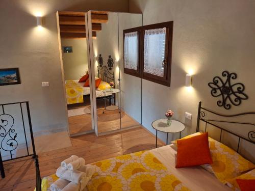 a bedroom with a bed and a room with a mirror at L'Oasi del Mediterraneo in Sampieri