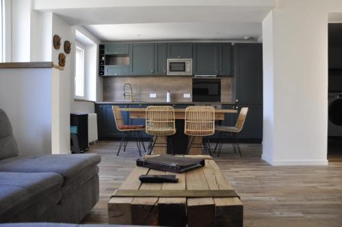 a kitchen and living room with a table and chairs at LedouxLand House near Disney in Bailly-Romainvilliers