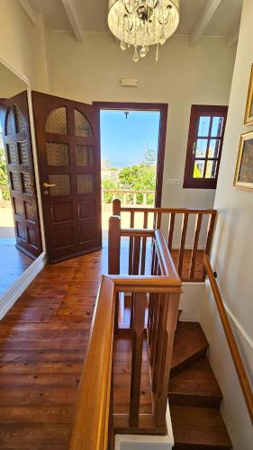 a room with a wooden staircase and a chandelier at Old Town Pearl in Rhodes Town