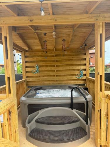 a sauna with a hot tub in a wooden building at House with a jacuzzi and solar panels in Boqueron