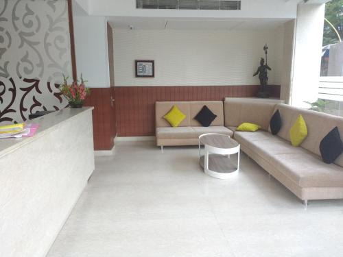 a living room with a couch and a table at Aura hotel in Kolkata
