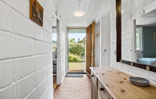 a hallway with a wooden table and a mirror at Amazing Home In Nykøbing Sj With Wifi in Nykøbing Sjælland