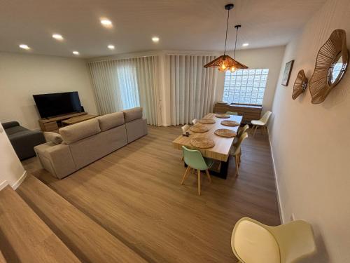 a living room with a dining table and a couch at Villas Sossego in Porto Santo