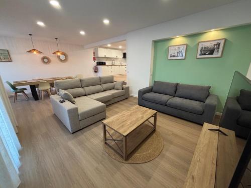 a living room with two couches and a table at Villas Sossego in Porto Santo