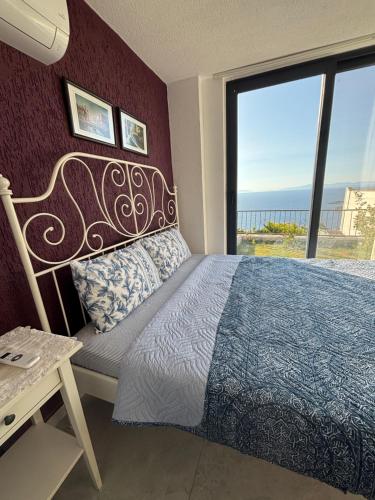 a bedroom with a bed and a view of the ocean at Selinshouse in Bodrum City