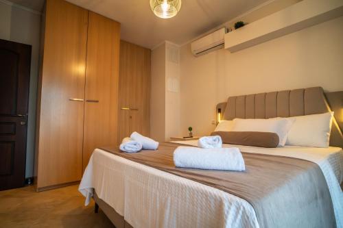 a bedroom with a large bed with towels on it at Bella Panorama in Alexandroupoli