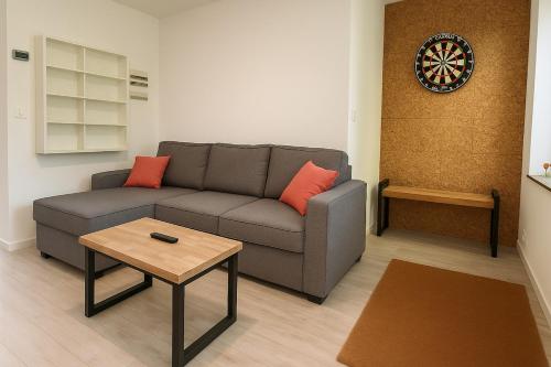 a living room with a couch and a table at Joli T2 esprit LOFT in Loos
