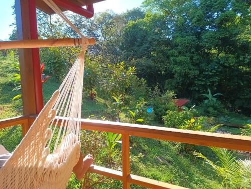 a hammock on a porch looking out at a garden at Thoas Lodge in Coronado