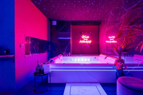 a bathroom with a tub with red lights in it at Toulouse Love room, suite avec spa privatif in Toulouse