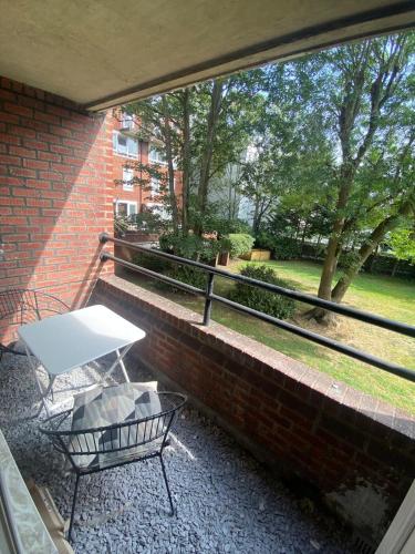 a white table and chairs on a brick wall at Spacious New London Apartment! in London