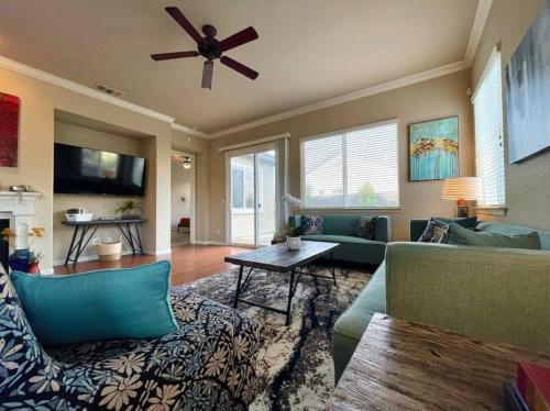 a living room with a couch and a ceiling fan at One Story Pet & Family Friendly Fireplace in West Sacramento