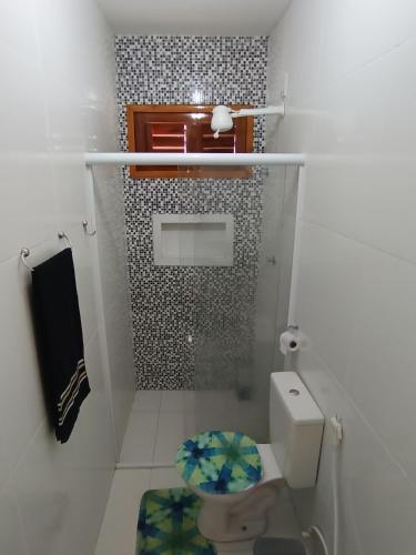a small bathroom with a toilet and a shower at Chalé Serrano in Tianguá
