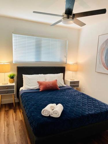 a bedroom with a bed with two towels on it at Remodeled Excellent Neighborhood in Roseville