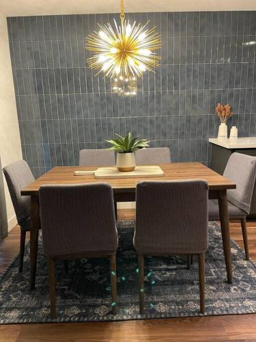 a dining room table with chairs and a chandelier at Remodeled Excellent Neighborhood in Roseville