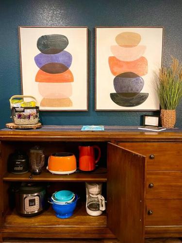 a wooden cabinet with two pictures on top of it at Remodeled Excellent Neighborhood in Roseville