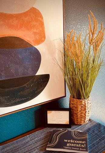 a vase with grass in it sitting on a table at Remodeled Excellent Neighborhood in Roseville