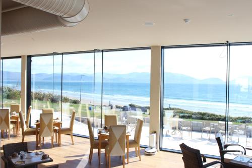 a dining room with a view of the ocean at Inch Beach House B&B in Inch