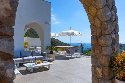 a patio with a couch and a table at Villa Marianna in Massa Lubrense