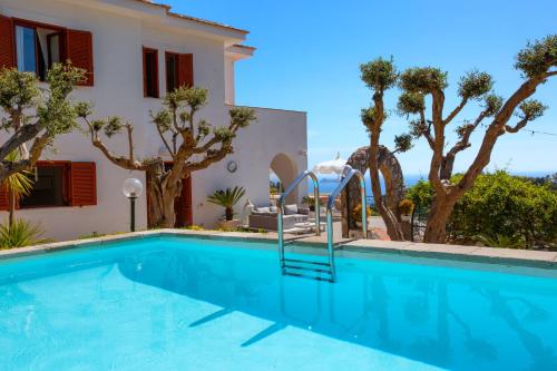 a swimming pool in front of a villa at Villa Marianna in Massa Lubrense