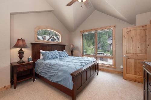 a bedroom with a large bed and a window at Lakota Lookout private hot tub in Winter Park