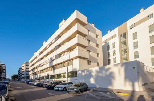 a parking lot in front of a large building at Refugio del Atlántico in El Puerto de Santa María