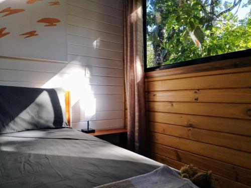 a bedroom with a bed next to a window at Thoas Lodge in Coronado