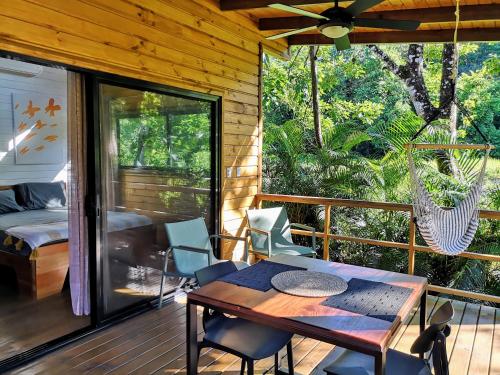 a room with a table and chairs on a porch at Thoas Lodge in Coronado