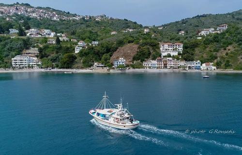 a boat in a large body of water at Mantemi house in Skopelos Town