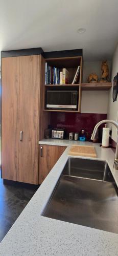a kitchen with a sink and a counter top at The Rocks Chalets in Takaka